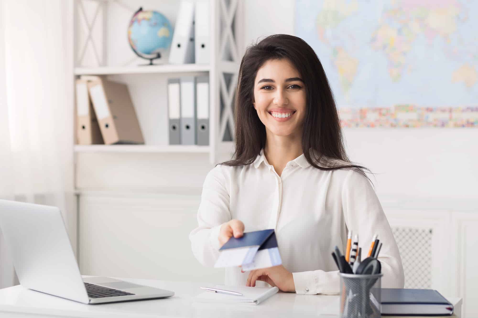 Female travel agent giving passports with airline tickets professional passport