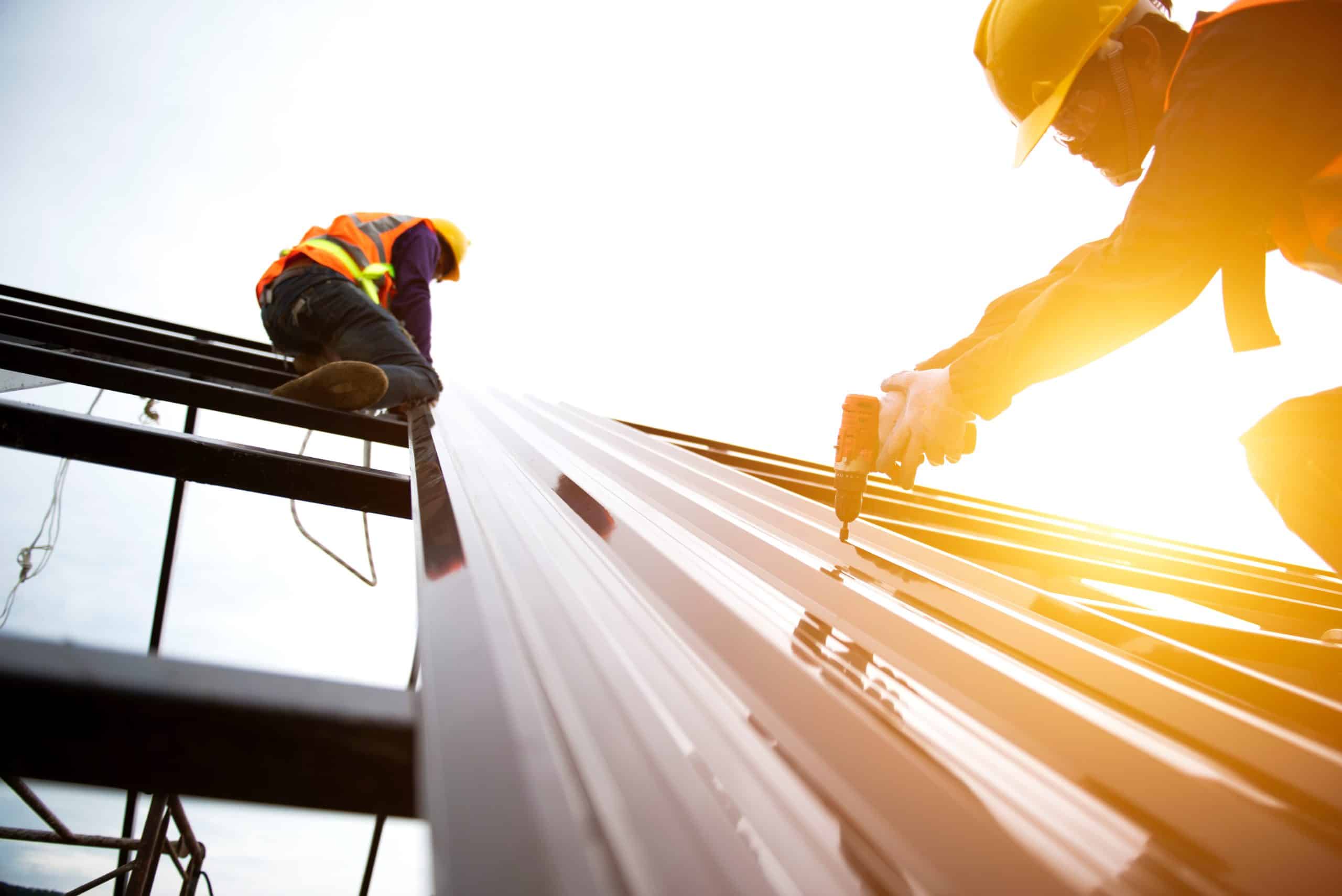 Asian construction workers wear safety straps while working on t CIS Payroll Birmingham