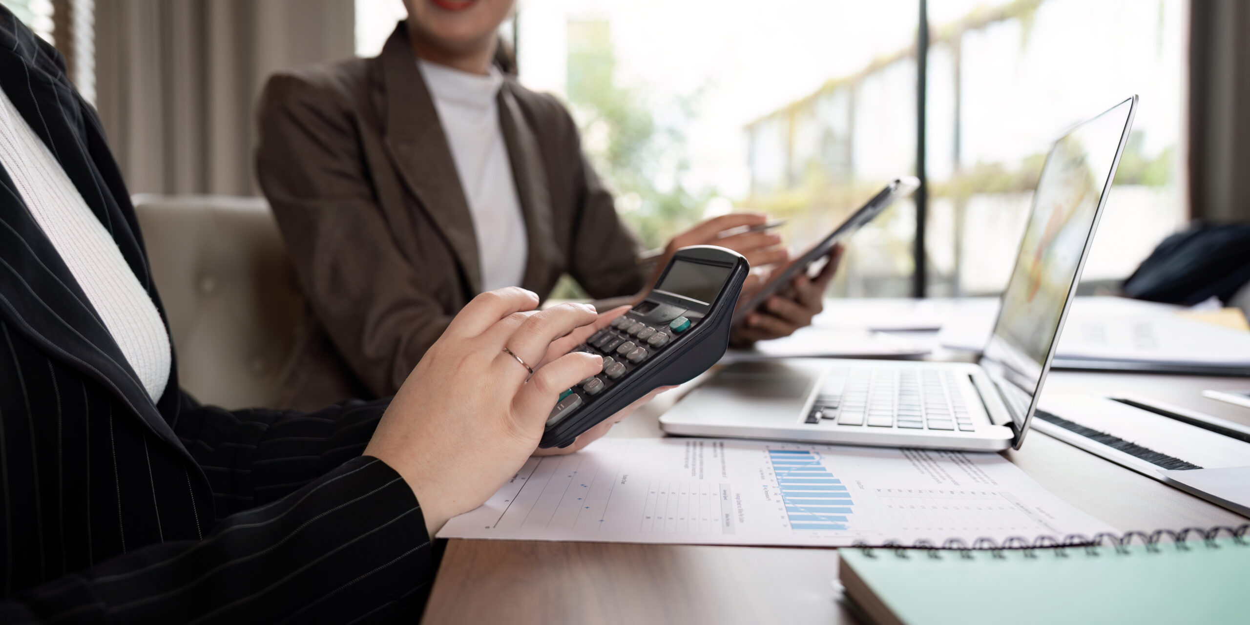 Financial Analyst Using Calculator for Data Review in Strategy Meeting. Concept of Collaborative Business Planning